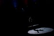 silhouette of aerial acrobat on rope in circus