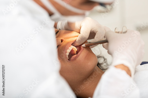 Young woman being seen in a dentist\'s office. Concept of toothache, wisdom tooth extraction, anesthesia, problems with caries or gums. Oral health care. Dentist day.