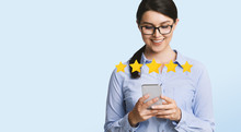 Happy Businesswoman Evaluating Mobile Application On Smartphone With Five Stars