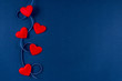 Red hearts with ribbon on classic blue 2020 color background. Valentines day 14 february concept. Flat lay, copy space, top view, banner.