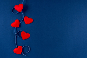 red hearts with ribbon on classic blue 2020 color background. valentines day 14 february concept. fl