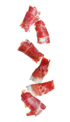 Falling delicious sliced jamon on white background