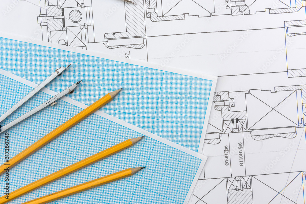 Technical drawing, graph paper and tools. Engineer office team working ...