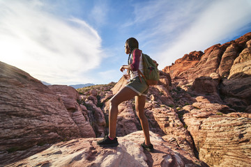 Wall Mural - female hiker with water bottle looking at landscape at red rock canyon
