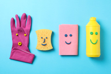 Flat lay with detergent and cleaning supplies on blue background, top view