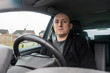 © Matthew Ashmore - A middle aged man sat in the driving seat of a car.