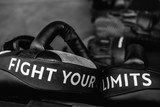 Fototapeta  - Close up of FIGHT YOUR LIMITS word on black boxing and kicking practice pad. Motivational and inspirational quote.