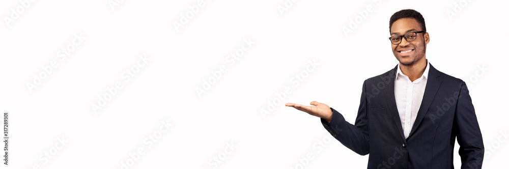 Smiling black man with his palm up over white background - obrazy, fototapety, plakaty 