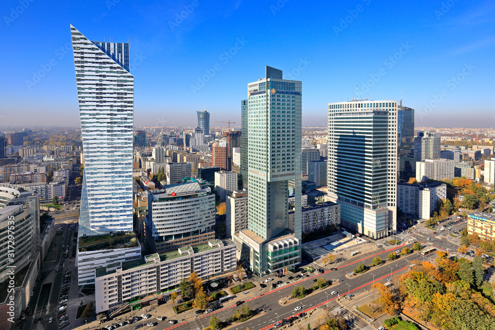 Panoramic aerial view of the skyscrapers - Zlota 44, Intercontinental and Warsaw Financial Center at the Emilii Plater street - in the Srodmiescie downtown district of Warsaw, Poland - obrazy, fototapety, plakaty 