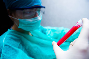 Woman scientist doctor with test tube in hand. creating a vaccine.