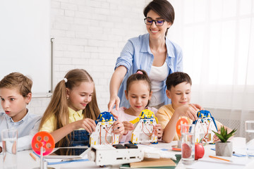 Poster - Pupils constructing modern robots with teacher's help