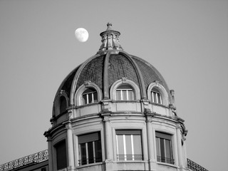 Genova, Italy - 01/22/2020:  Panoramic view to the city center of Genoa in winter beautiful day. Amazing view to the old architecture with blue sky in the background and the moon over the city.