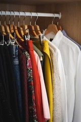 Poster - Lot of different clothes hanging in a wardrobe