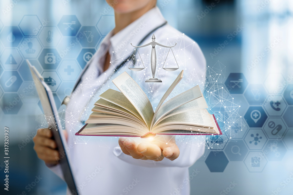 The doctor shows the tutorial and the scales of justice . Stock Photo ...