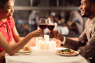 African American Couple Clinking Glasses Celebrating Anniversary In Restaurant