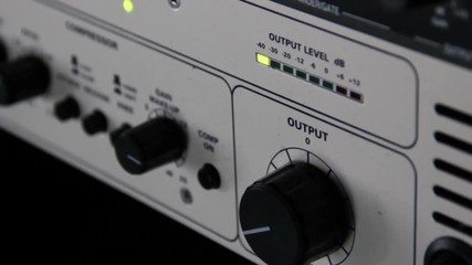 Wall Mural - A rack of audio compressors and other components of sound reinforcement system in a recording studio close up. Output knob and sound level control macro.