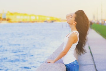 Side view profile portrait of a happy brunette woman relaxing breathing fresh air outdoors in summer Girl close eyes doing deep breath exercises. Positive emotion success, peace of mind, zen concept.