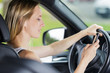 © auremar - woman checking her phone while driving