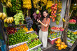 © Juan Alberto Ruiz/ADDICTIVE STOCK - From above of Asian pleased woman on vacation in casual clothing making choice of fresh fruits at market at Sri Lanka