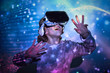 © PHILIPPE DEGROOTE/ADDICTIVE STOCK - Boy wearing virtual glasses standing in colorful lights
