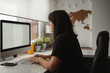 © Raquel Arocena/ADDICTIVE STOCK - Side view of concentrated dark haired female employee focusing on screen and typing on computer while sitting at table in light office in Paris