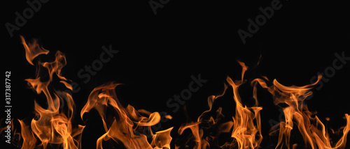 Fotomural flame of fire isolated on black background in panorama