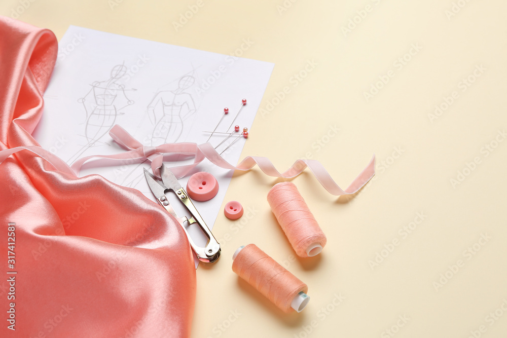 Set of tailor's supplies with sketch on color background