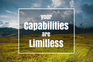 Inspirational and Motivational Quote. Your Capabilities are Limitless. Grass Against Sky Background.