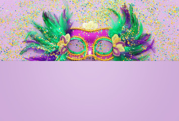 Holidays image of mardi gras masquarade venetian mask over purple background. view from above