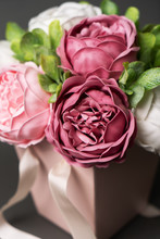 Flowers In Bloom: Bouquet Of Lilac And Pink Peonies In A Pink Square Box On A Gray Background.