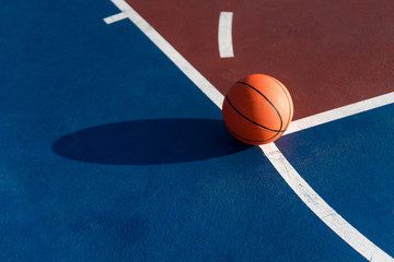 An orange ball on basketball court