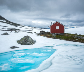 Wall Mural - Typical norwegian red wooden house near famous Aurlandsvegen (Bjorgavegen) mountain road in Aurland, Norway in summer time. Landscape photography