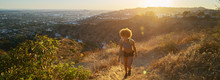 Athletic African American Woman Hiking Up Runyon Canyon Trail At Sunset