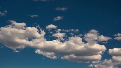 Wall Mural - Timelapse of white puffy clouds in a deep blue Colorado sky