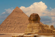 © Mountains Hunter - Sphinx against the backdrop of the great Egyptian pyramids. Africa, Giza Plateau.