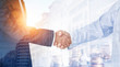 © Pixel-Shot - Multiple exposure of business partners shaking hands, coins and modern city