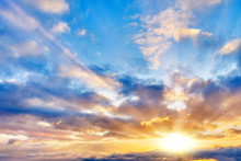 Sunset Sky Landscape Background Natural Color Of Evening Cloudscape With Setting Sun Light Coming Through Clouds Wide View