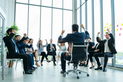 Fotomural Rear view of Business colleagues discussing report at modern office