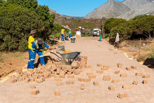 Rooiels, Western Cape, South Africa. December 2019. Workers Laying A Brick Road In The Small Hamlet Of Rooiels.