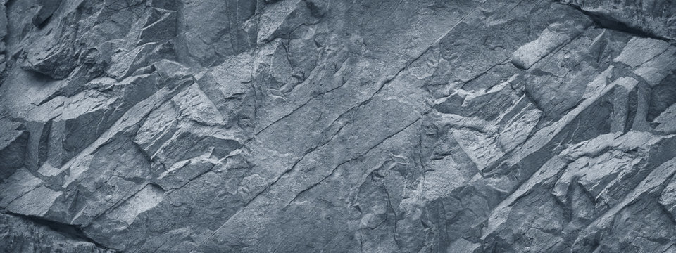 Wall Mural -  - Gray grunge banner. Abstract stone background. The texture of the stone wall. Close-up. Light gray rock backdrop.