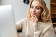 © Drobot Dean - Optimistic young woman using laptop computer.