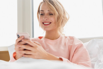 Poster - Woman indoors at home using mobile phone.