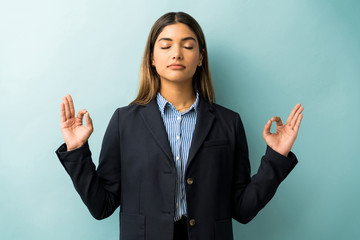 Wall Mural - Calm Businesswoman Performing Meditation In Studio