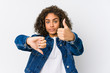 Young african american woman showing thumbs up and thumbs down, difficult choose concept