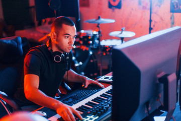 Sound engineer working and mixing music indoors in the studio