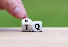 Hand Turns A Dice And Changes The Expression "IQ" (Intelligence Quotient) To "EQ" (Emotional Intelligence/Quotient).