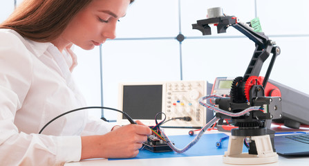 Poster - Woman student with robot model arm