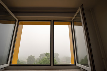 Canvas Print - View from the open window in foggy weather