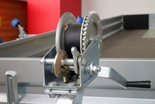 Detailed Photo Of The Construction Of A Small Metal Mechanical Wire Rope Winch With A Stainless Steel Hook
