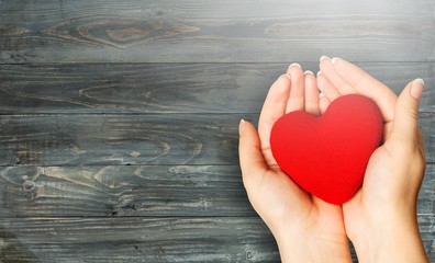 Poster - Hands of young woman holding red heart